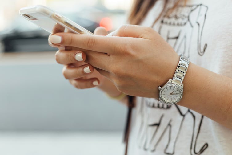 Young woman looks at phone