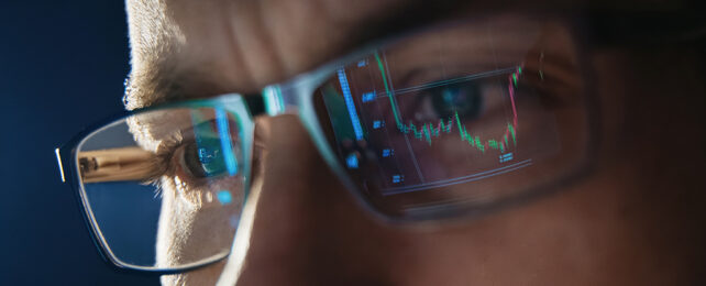 man with glasses with reflection of a graph