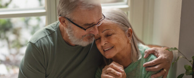 man holding elderly person