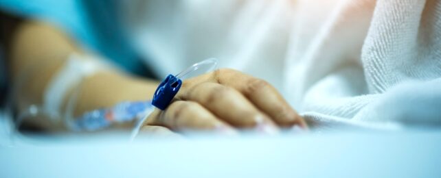 Patient Hand On Hospital Bed