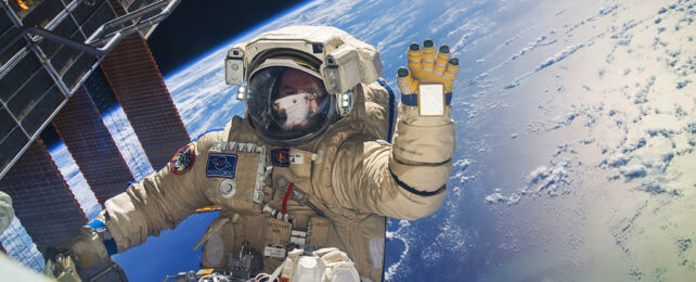 Russian cosmonaut waving outside of the ISS