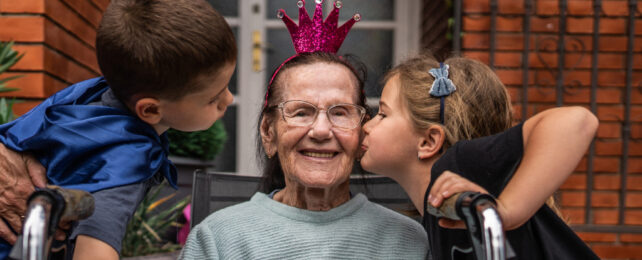 older person being kissed on the cheek