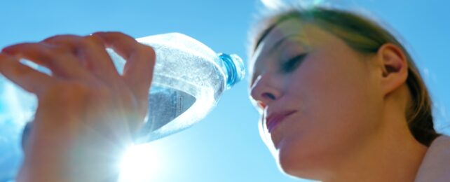 Woman Drinks Plastic Water Bottle